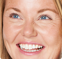 Close-up of a smiling woman with blue
eyes looking upward​