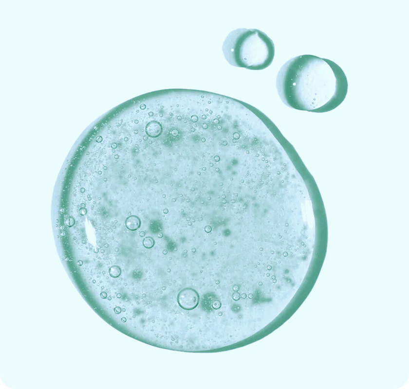 Close-up of green gel cleanser with
bubbles on a light background.