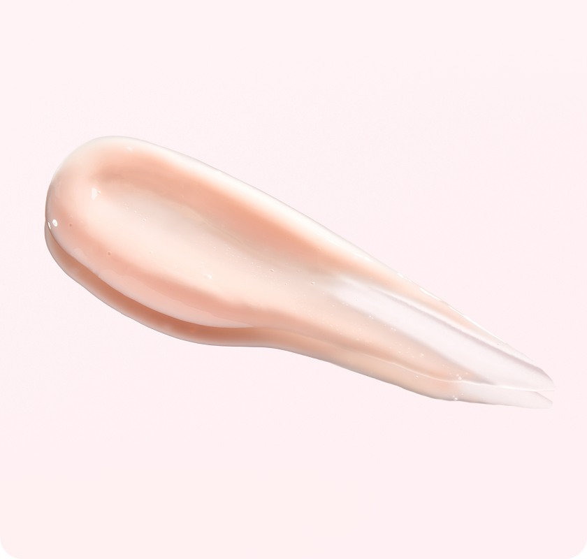 Close-up of a peach-toned skincare serum
smear on a light background.​