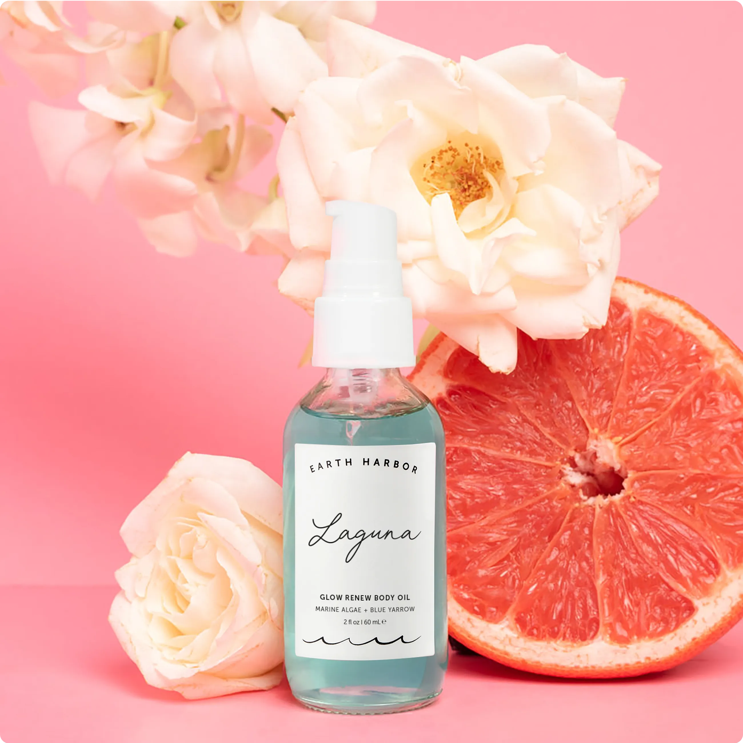 A bottle of Earth Harbor Laguna body oil
splashing into clear water ripples.​