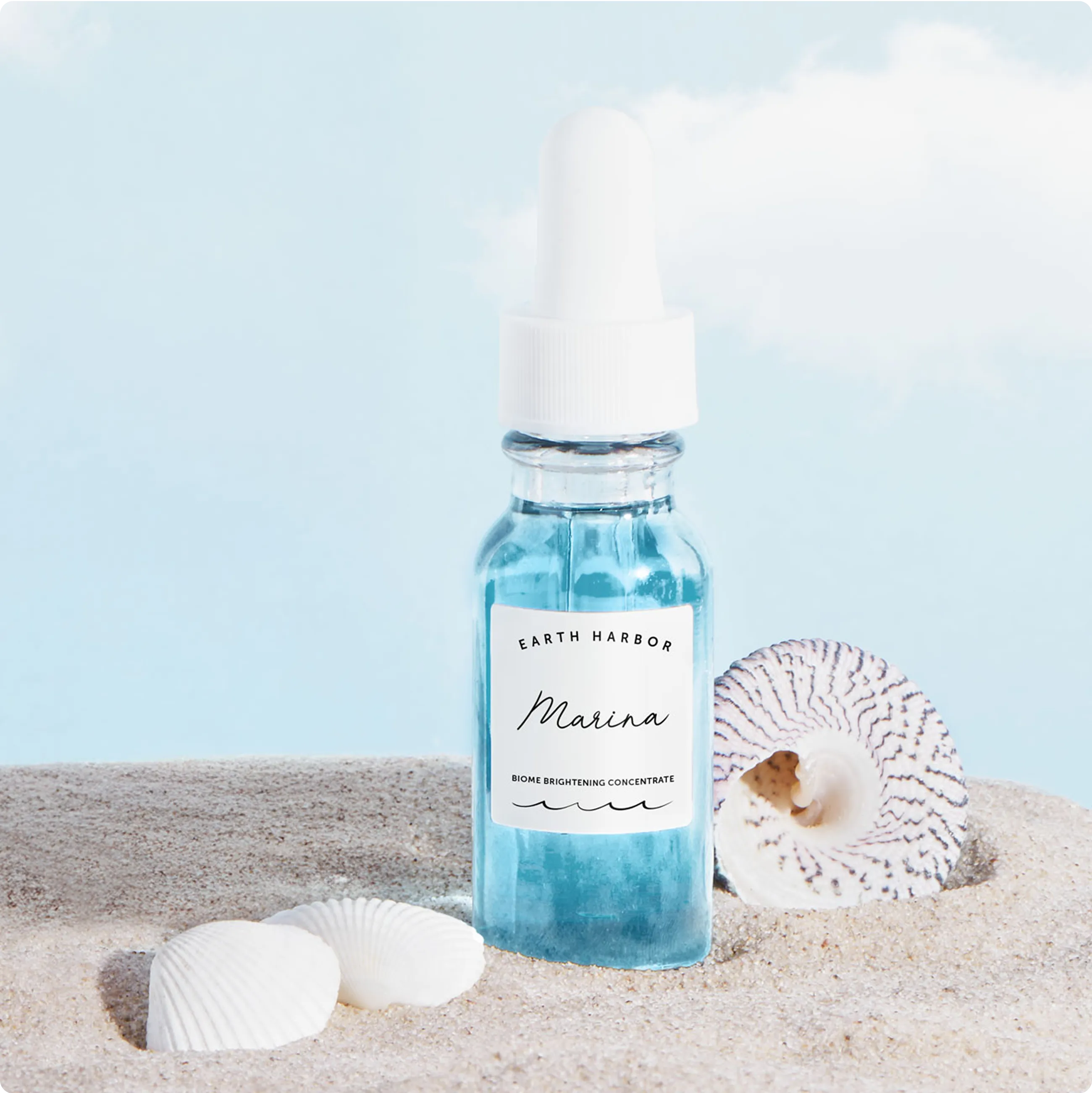 Earth Harbor Marina Biome Brightening
Concentrate bottle sitting in sand next to
sea shells.​