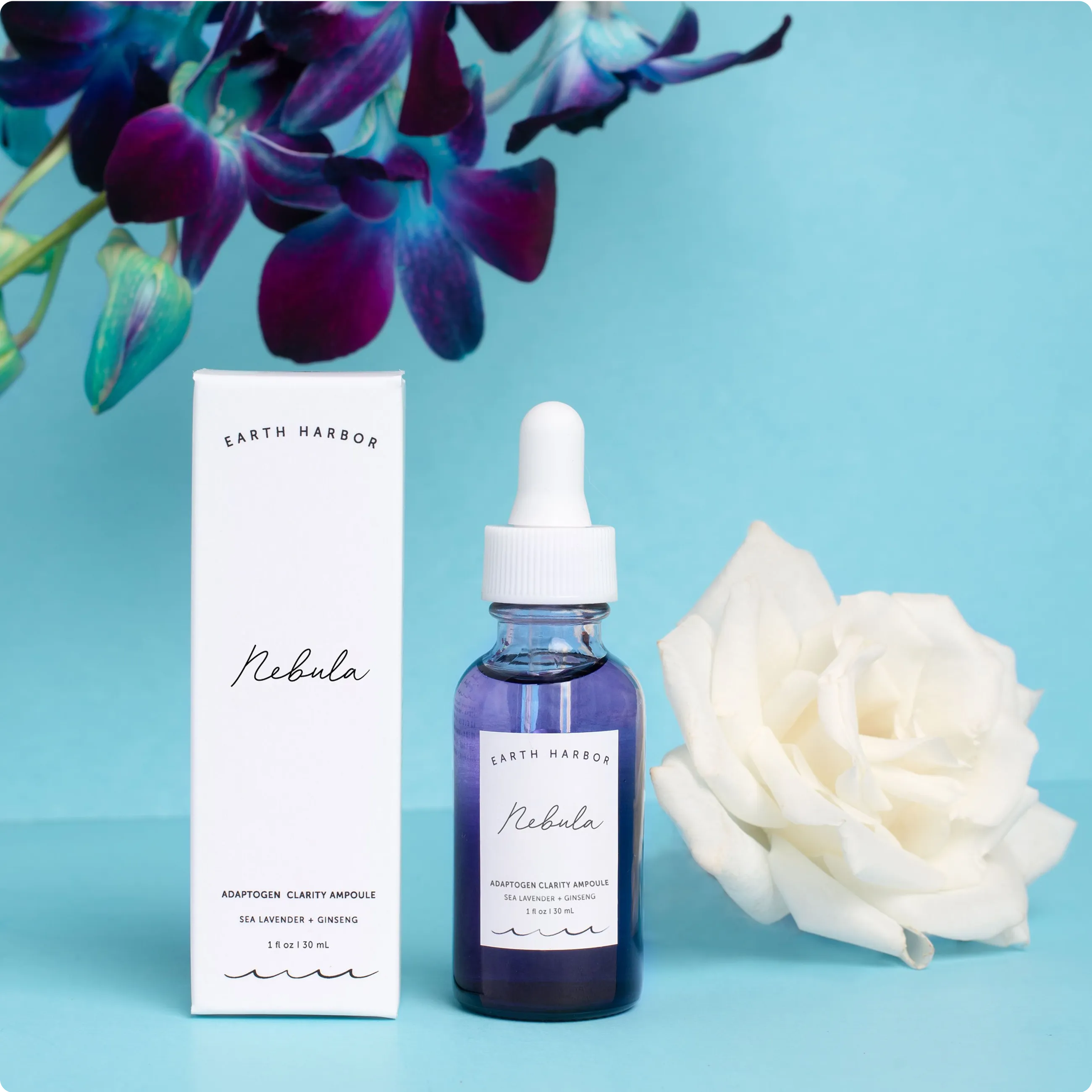 Earth Harbor Nebula purple ampoule
bottle and white box next to a white rose
on a light blue background.​