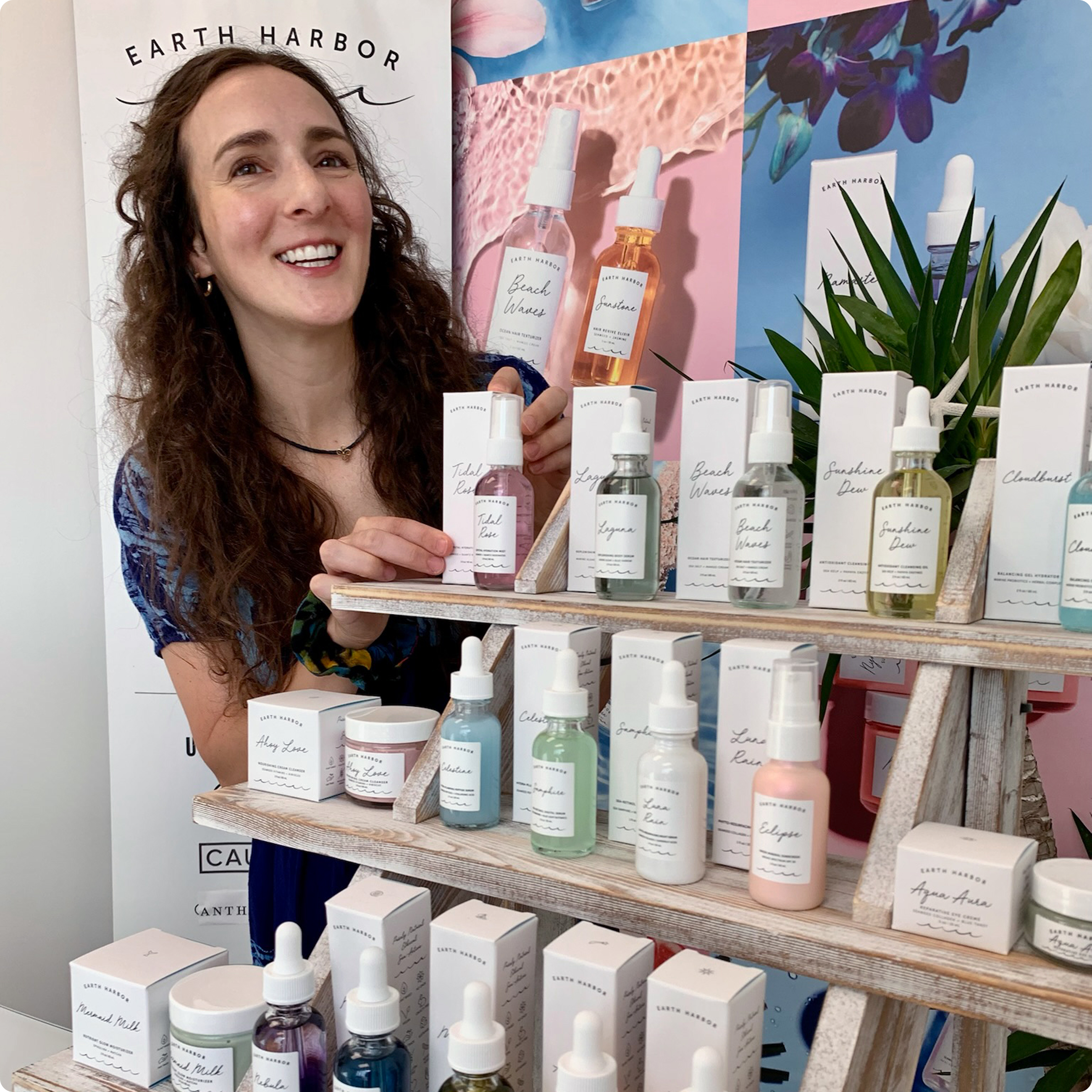 Woman standing at a skincare display
booth with products arranged on shelves.​