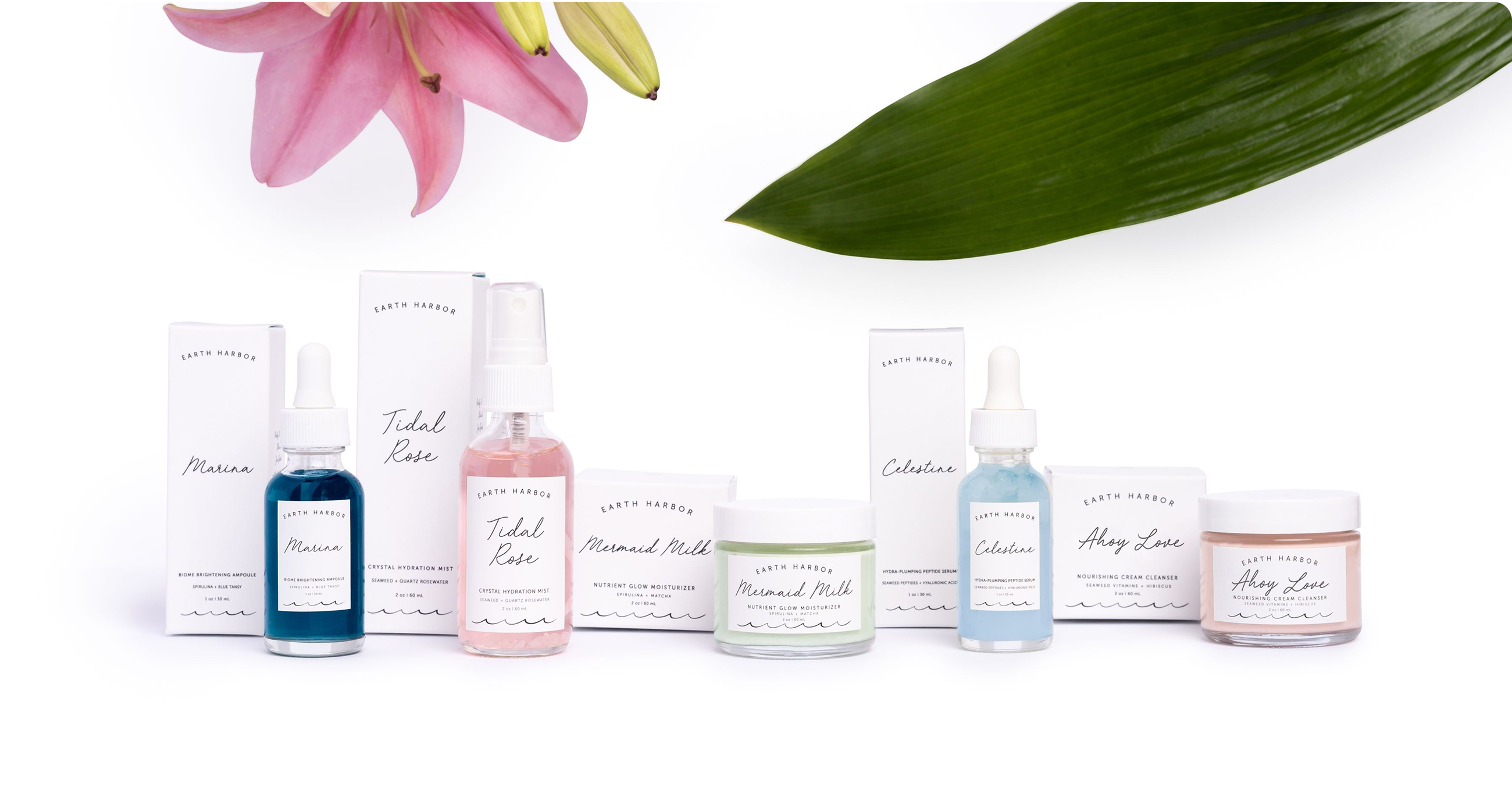 Earth Harbor products lined up with
packaging, flowers, and a green leaf.​