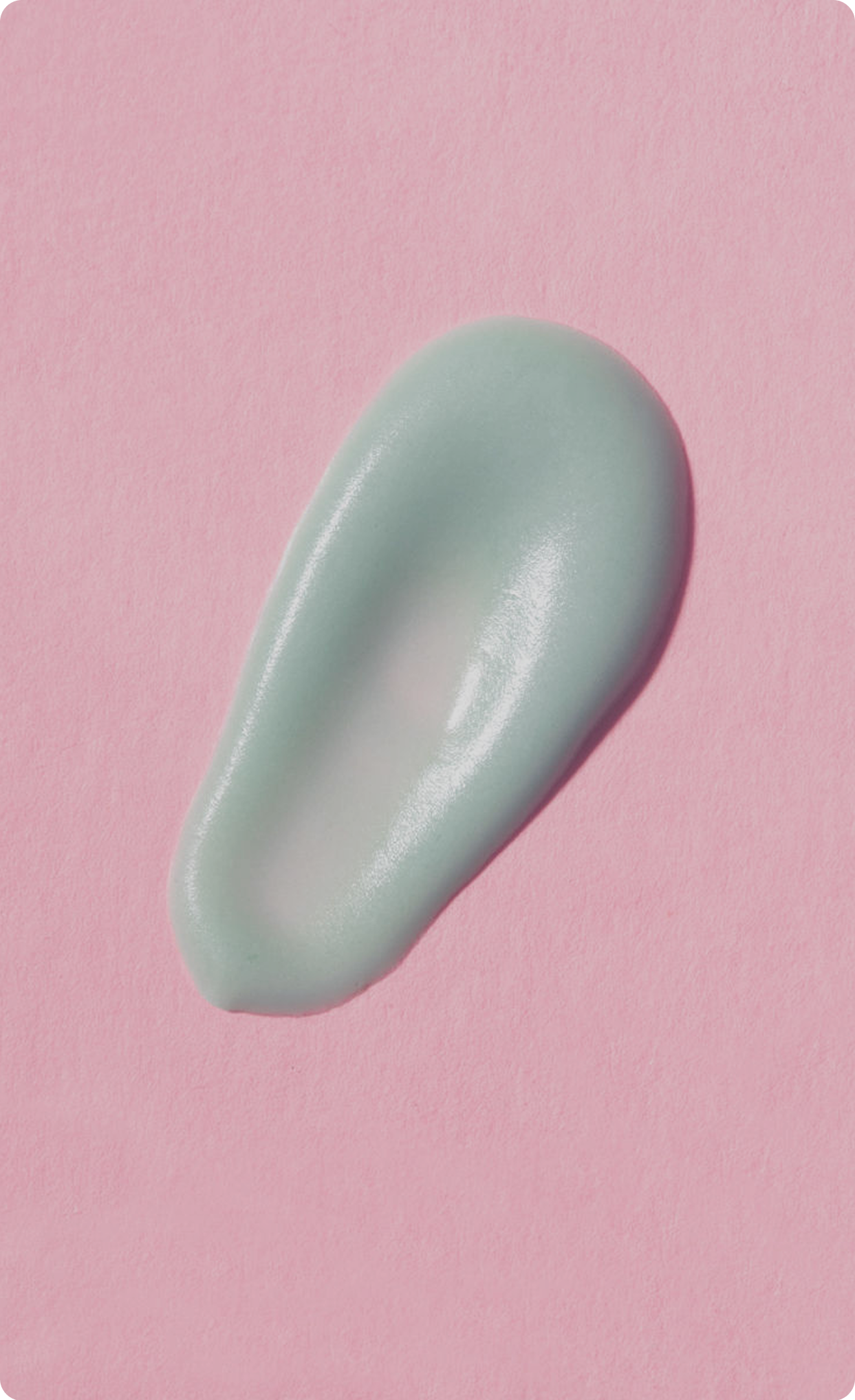 Close-up of a smooth swipe of green
cream on a pink background