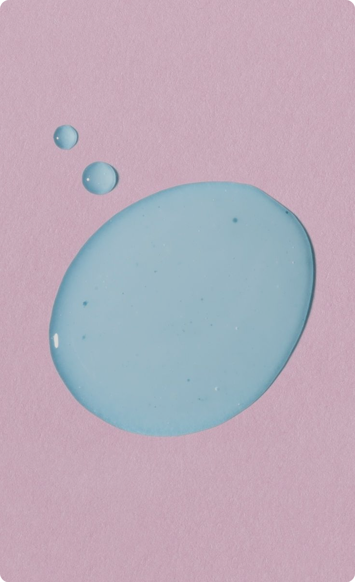 Close-up of blue skincare liquid droplets
on a pink background.