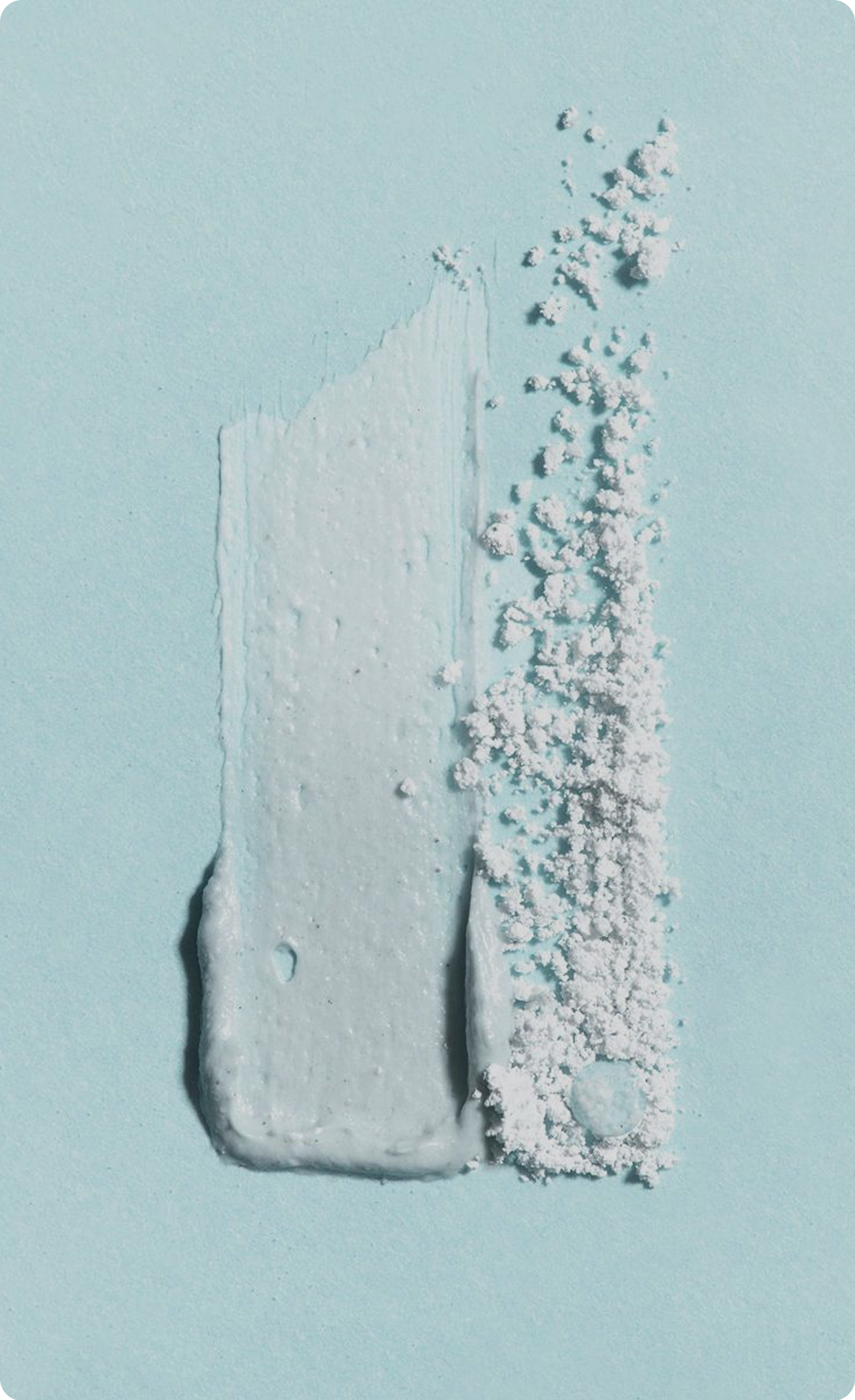 Close-up of a textured swipe of skincare
mask on a light blue background.​