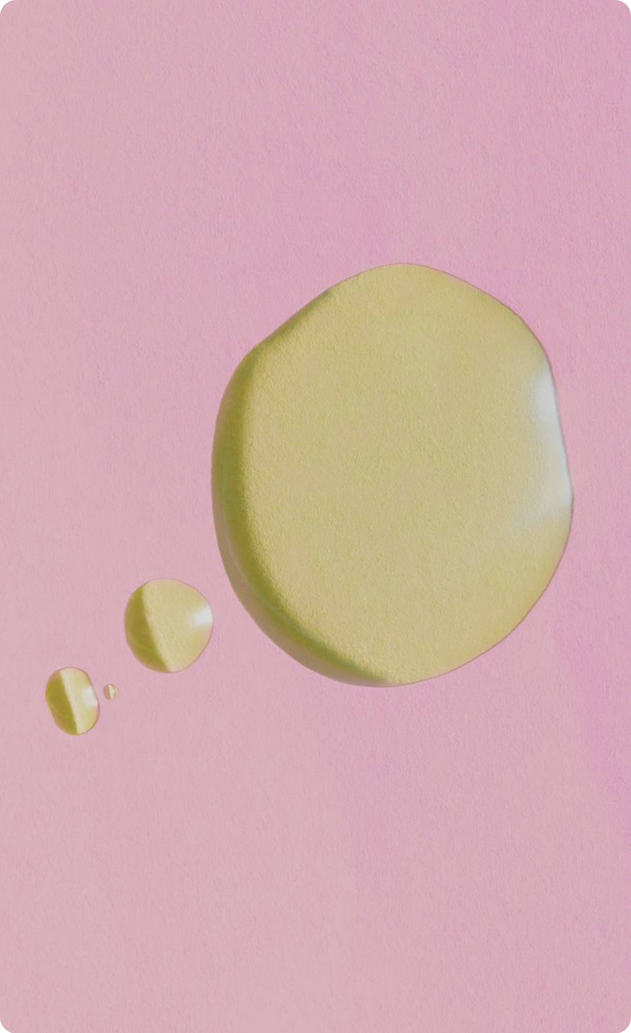 Close-up of yellow skincare oil droplets on
a light blue background.
