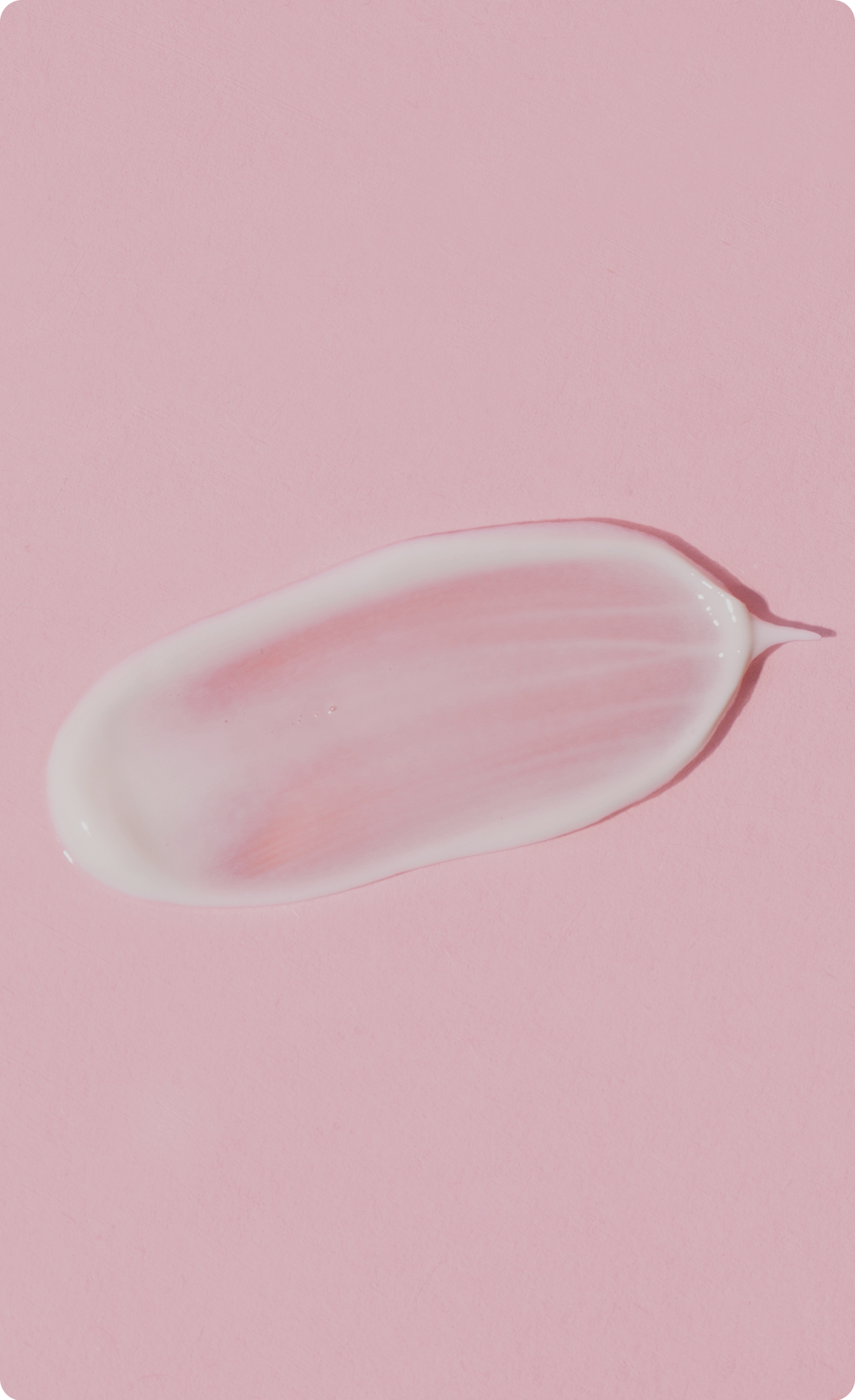 Close-up of a clear skincare gel smear on a
soft pink background.​