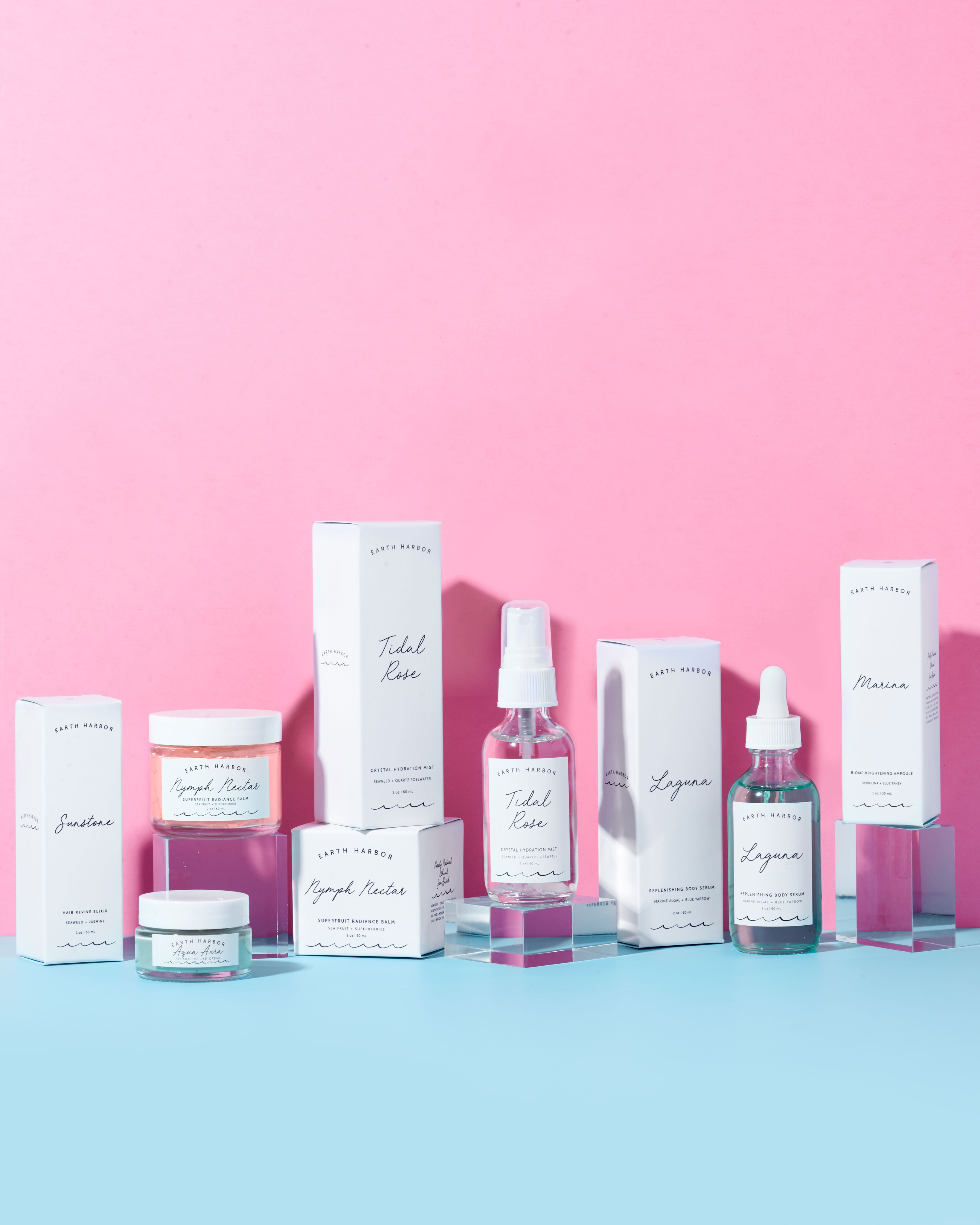 Earth Harbor products and packaging
arranged on a pink and blue background.​